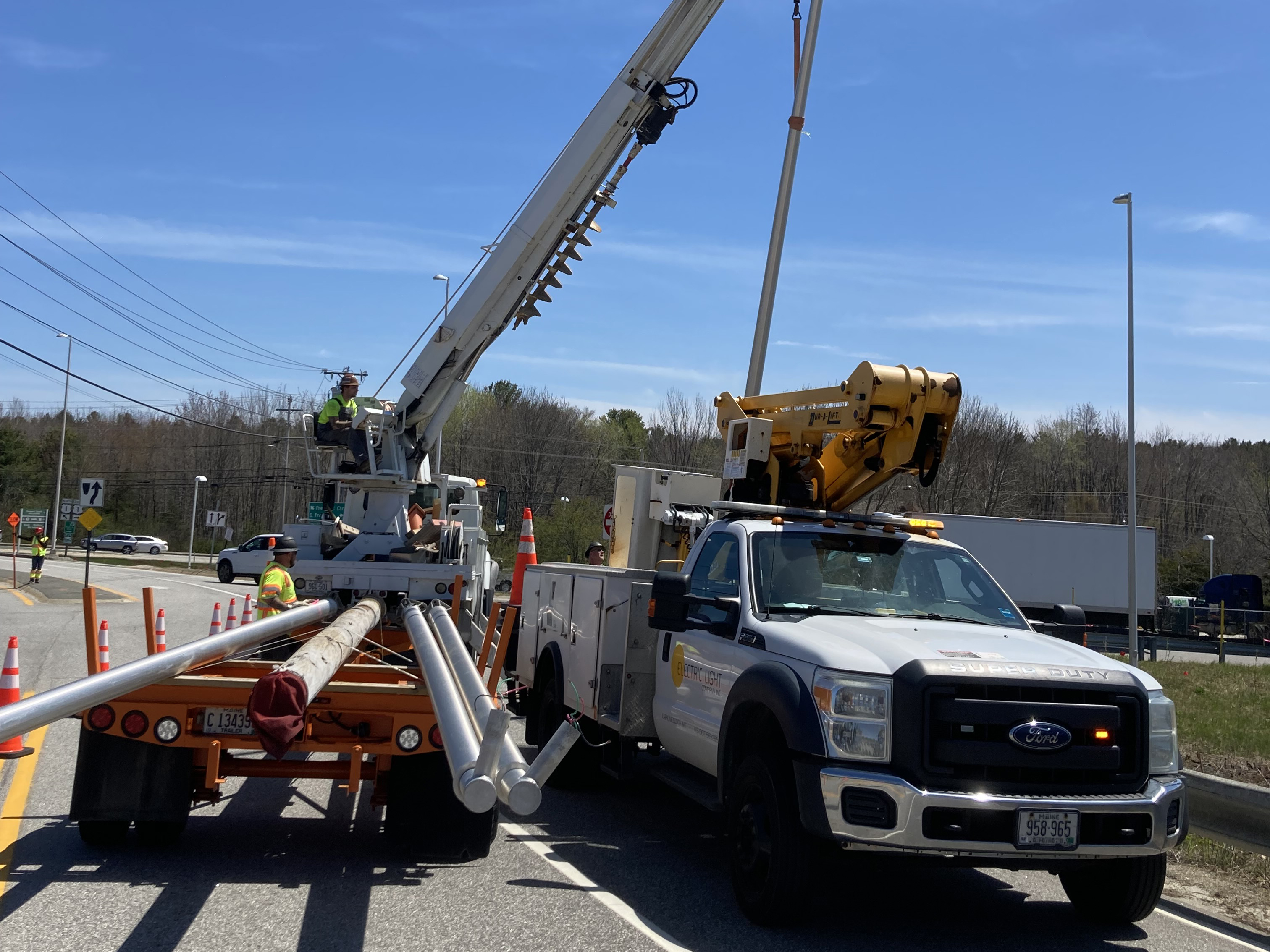 Light poles loaded onto truck for removal